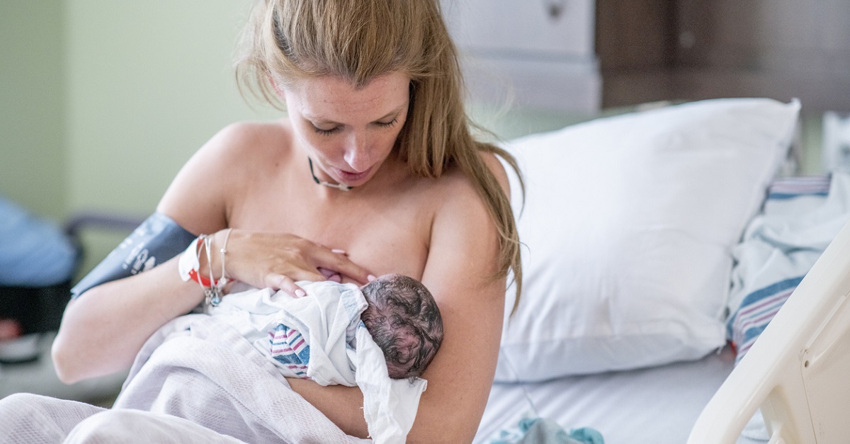 Young mother nurses her baby.