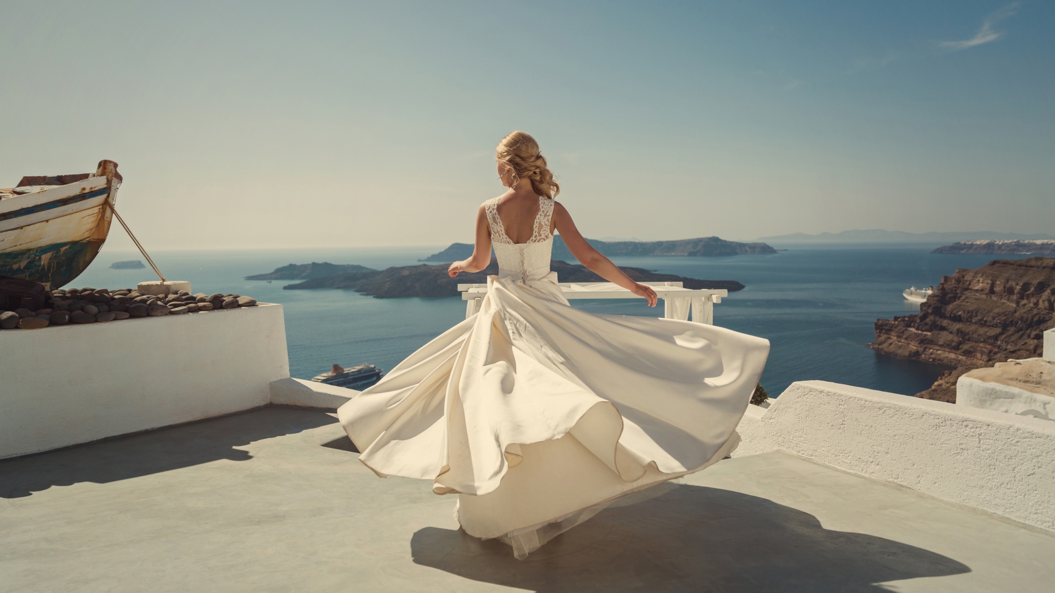 Bride in a beautiful dress, spinning and dancing on the sea