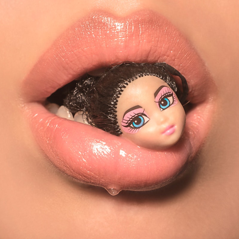 close-up-view-of-a-person-s-mouth-with-a-doll-head-3601539.jpg