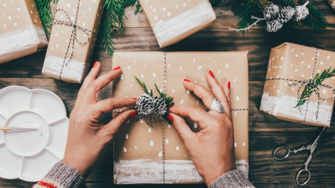 Woman wrapping Christmas presents in a crafty way