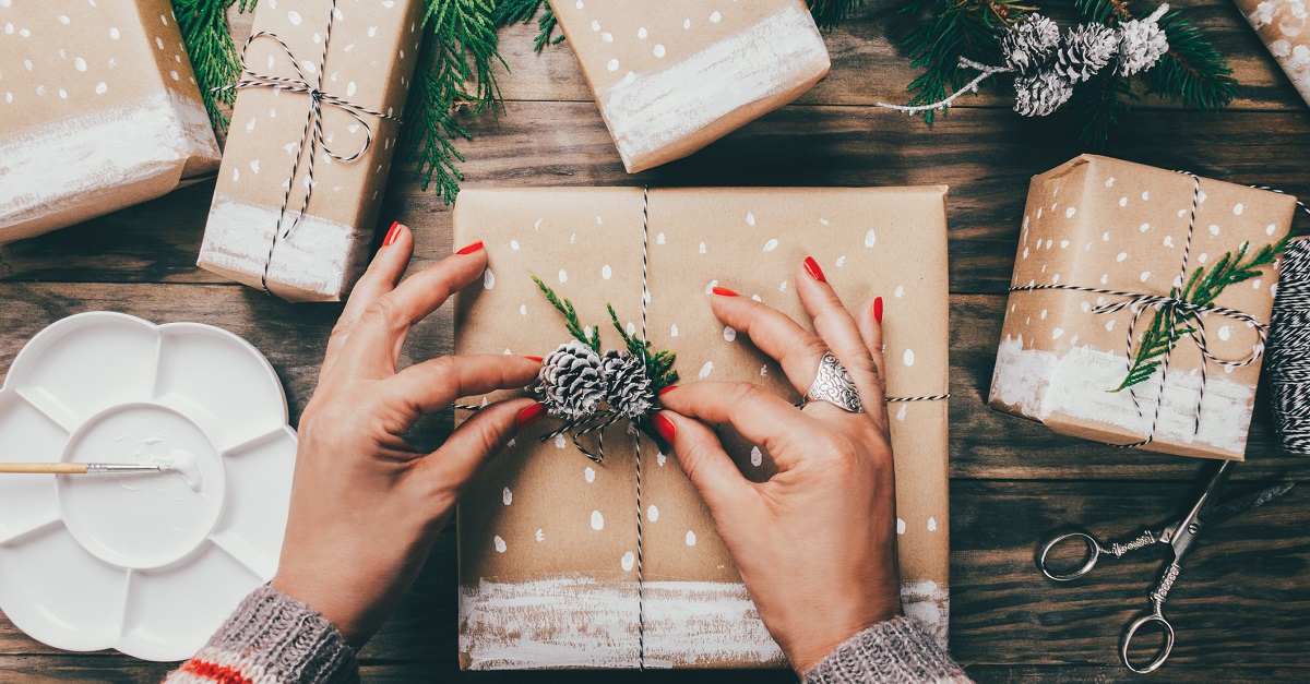 Woman wrapping Christmas presents in a crafty way