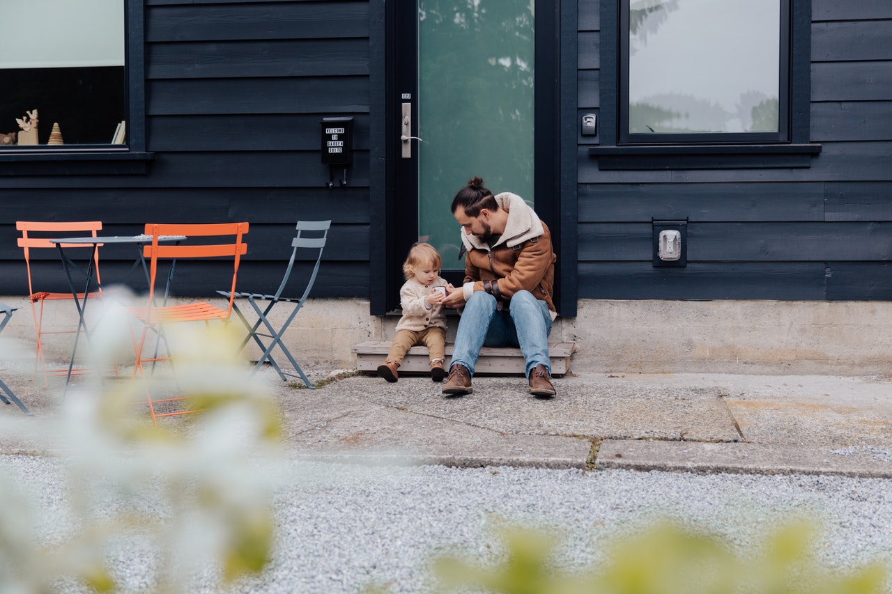 father-and-child-sitting-near-door-in-backyard-3850051.jpg