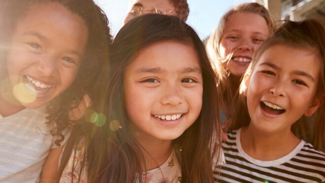 Elementary school kids smiling to camera at break time