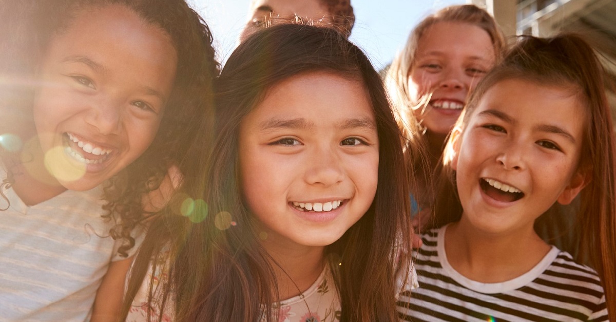 Elementary school kids smiling to camera at break time