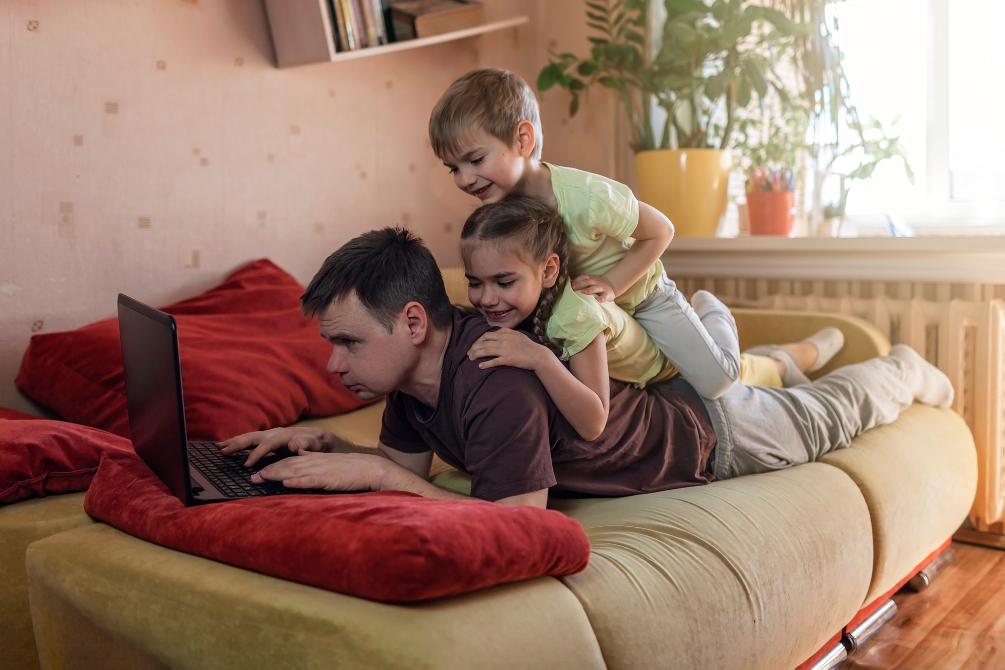 happy-man-with-children-using-laptop-and-earphone-during-his-home-working-life-in-quarantine-mobile_t20_pLykZd.jpg