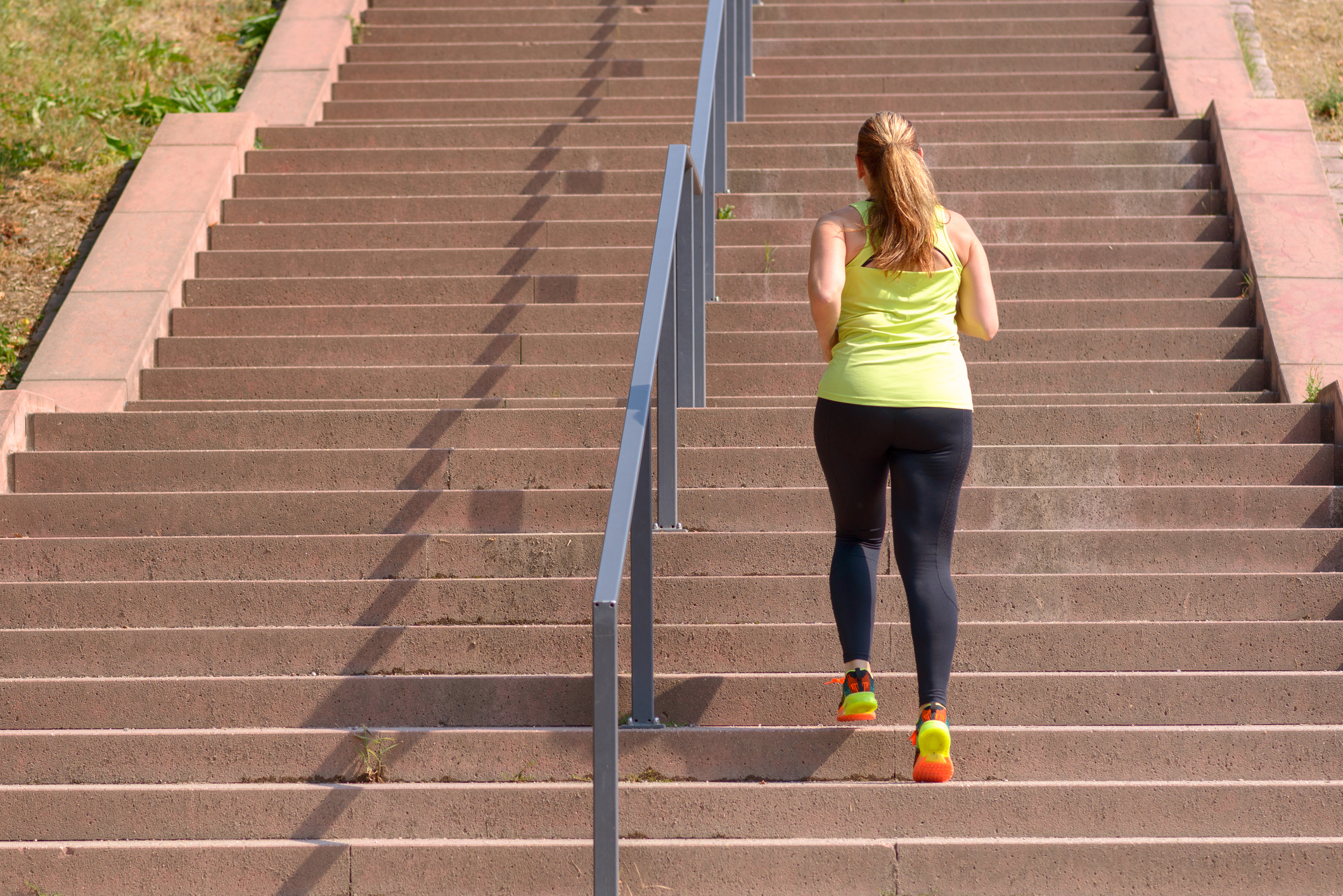 Woman running while climbing stairs during workout