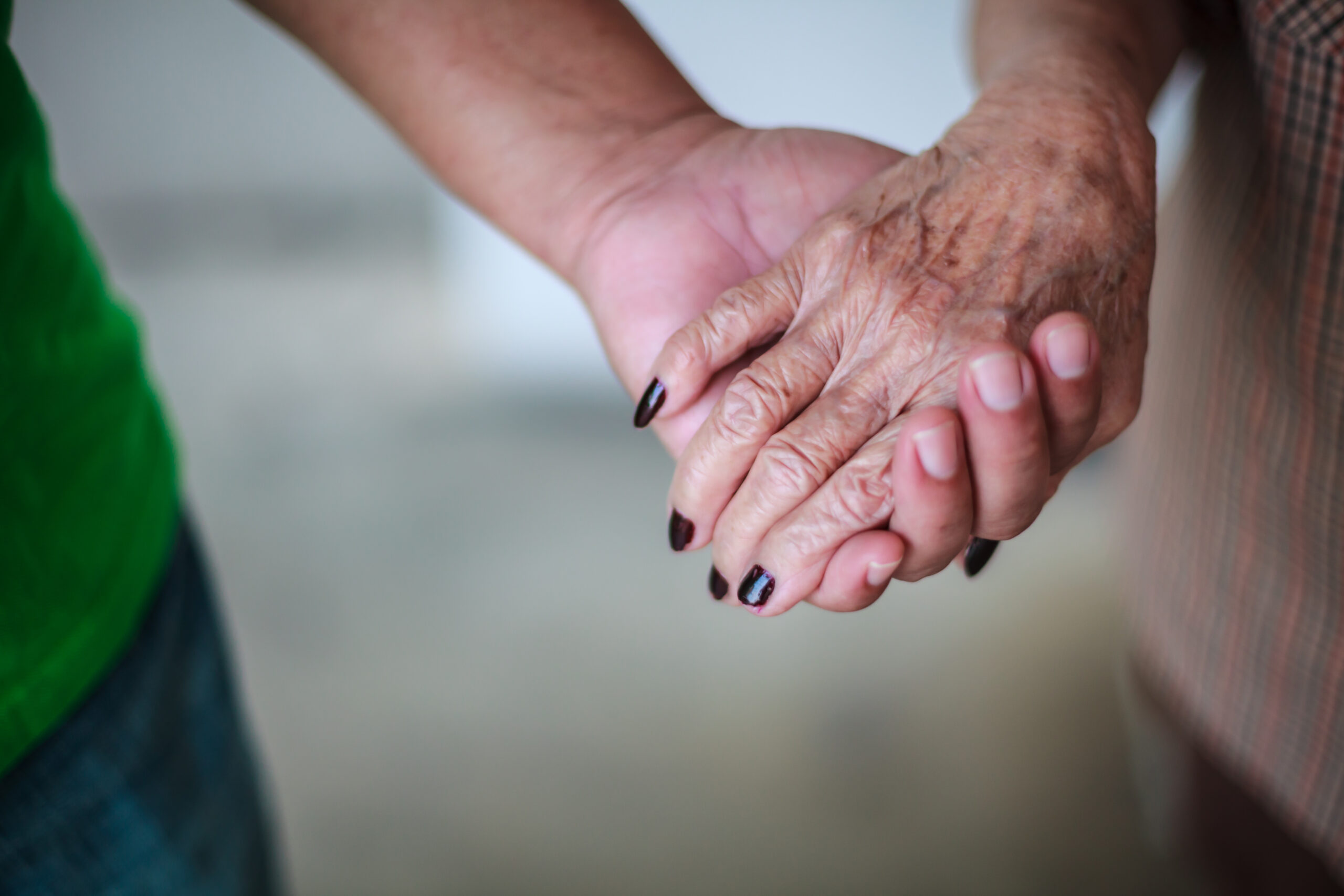 Older woman and grandson holding hands