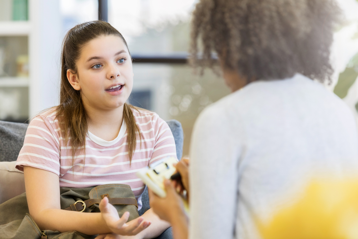 Teenage girl talks to school counselor