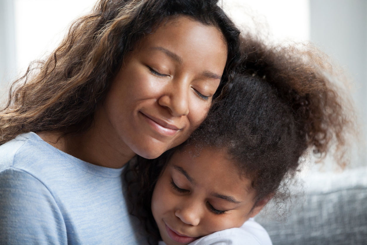 Loving black mother embrace little preschool daughter