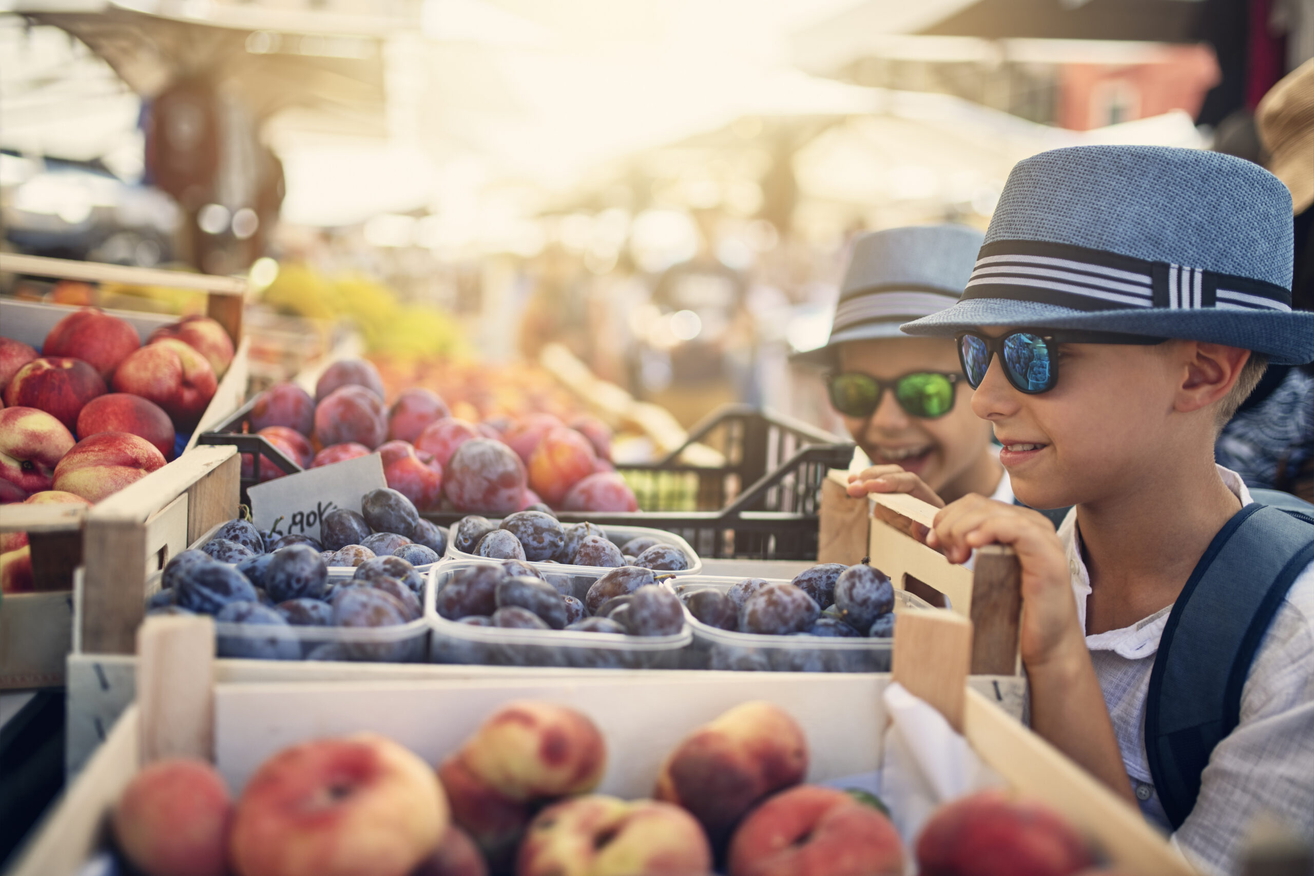 Kids buying fresh organic oranges at Verona street market