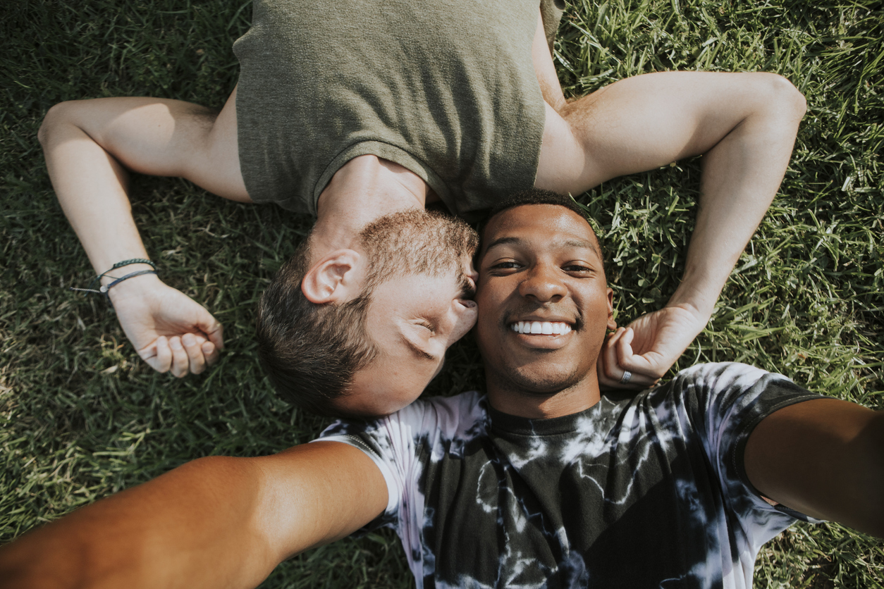 Gay couple relaxing in the grass