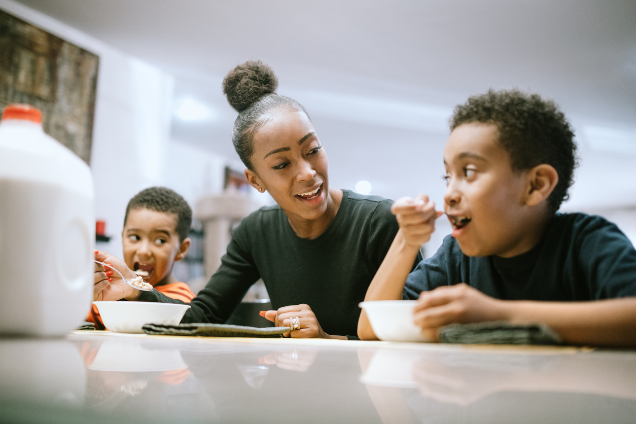 Mother Eating Breakfast With Her Two Boys