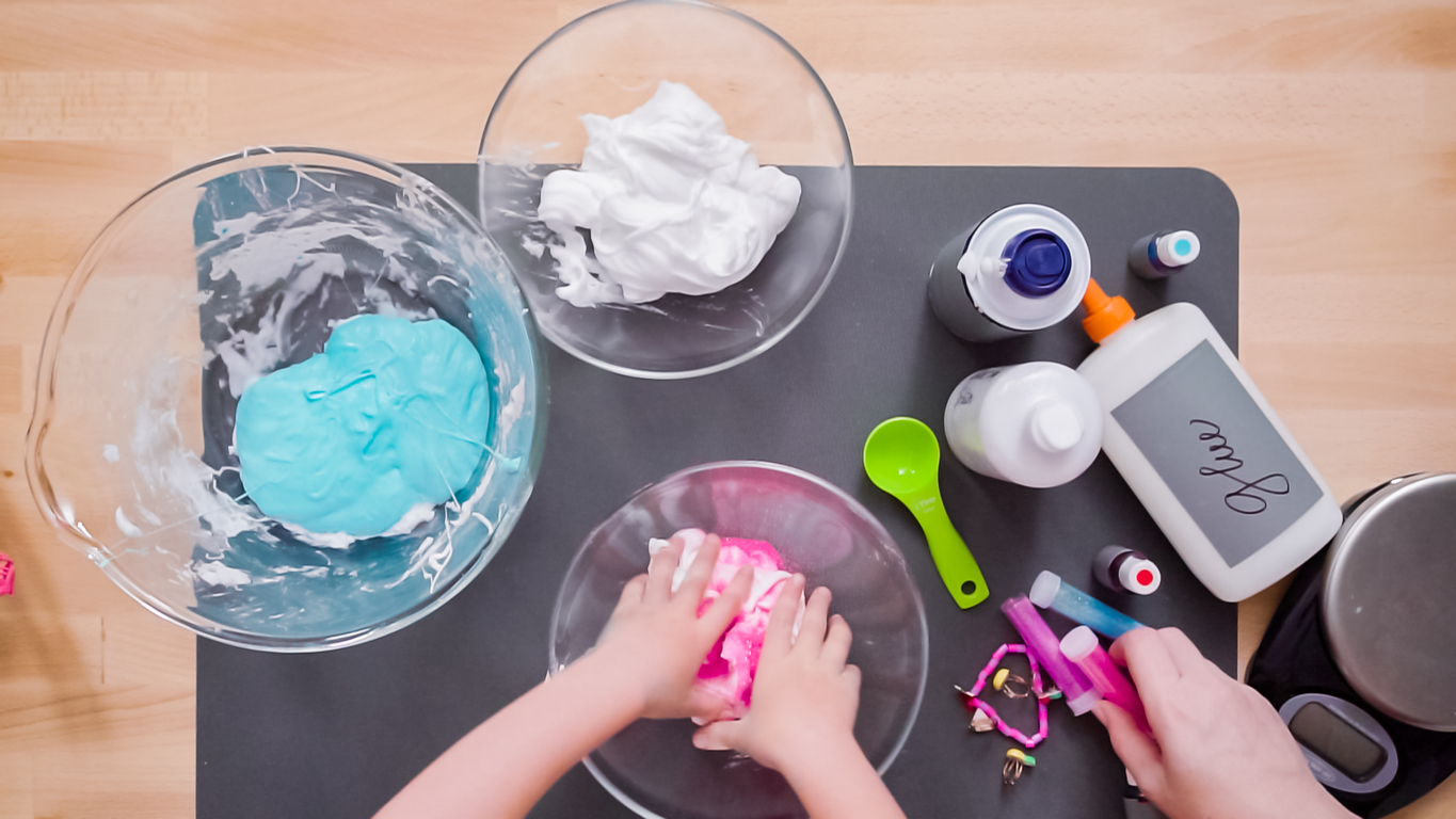 Mother and daughter making colorful fluffy slime.