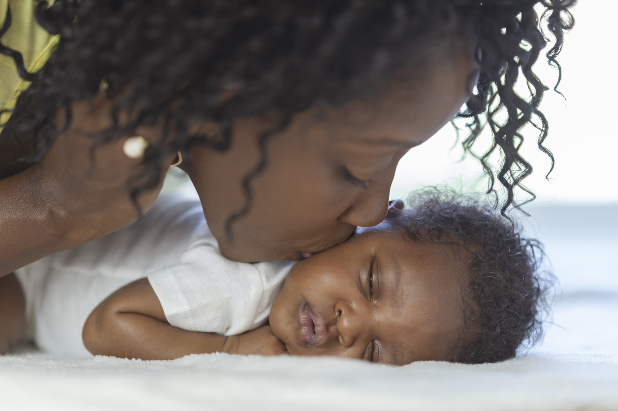 Kissing newborn boy