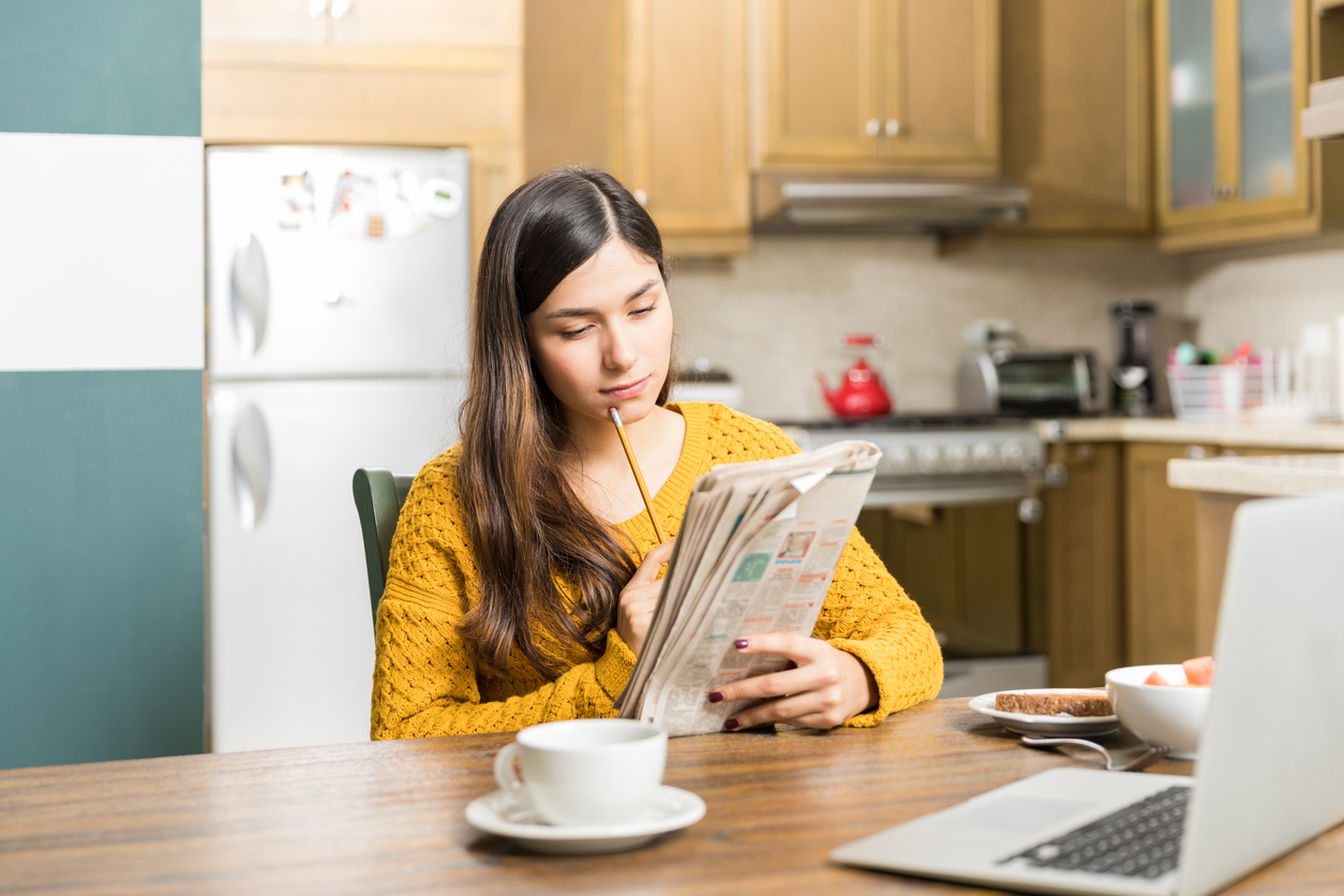 Woman Analyzing Newspaper Game Carefully