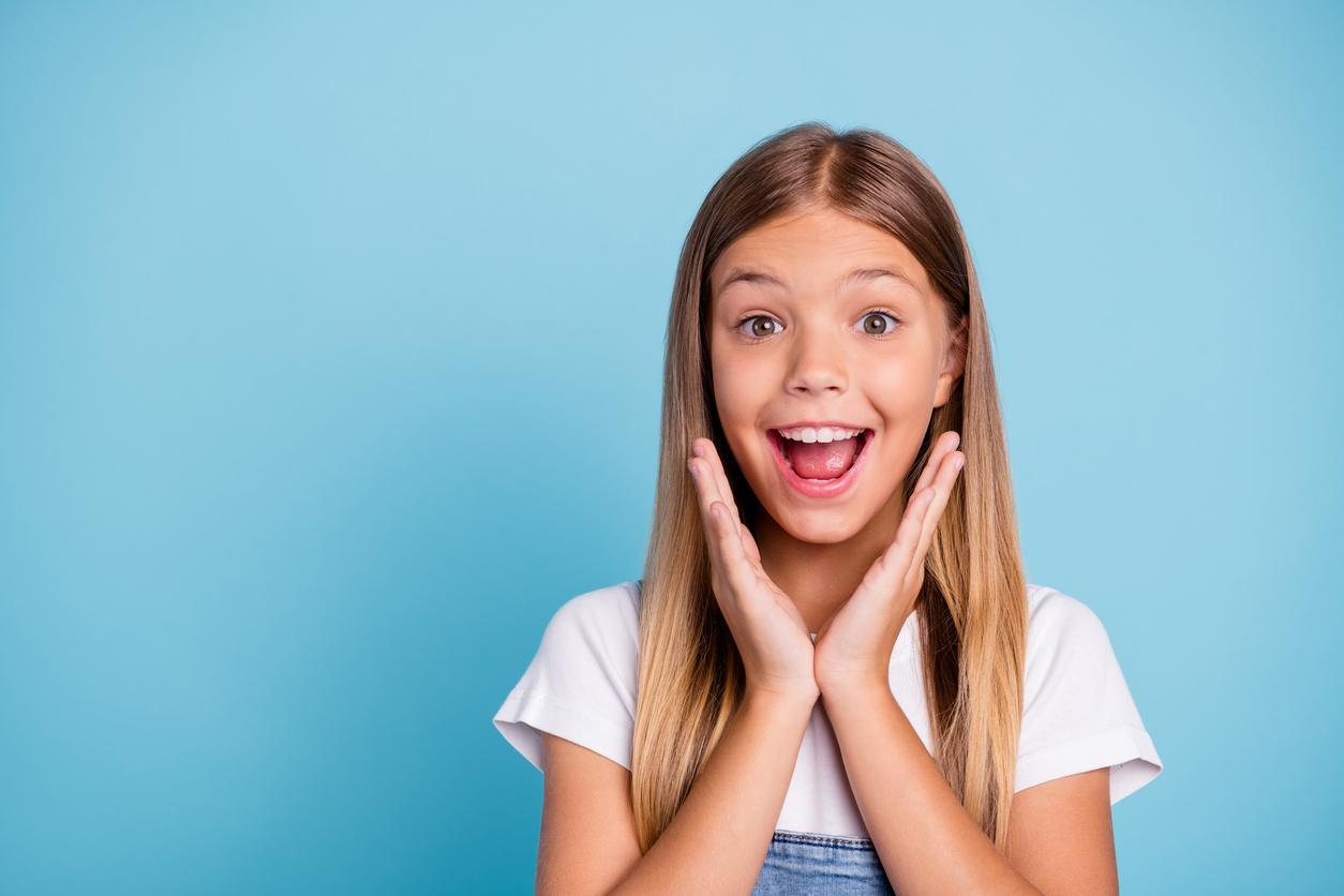 Close-up profile side portrait of her she nice cute lovely attractive cheerful amazed glad funny straight-haired blonde girl opened mouth gift present wish isolated on blue pastel background