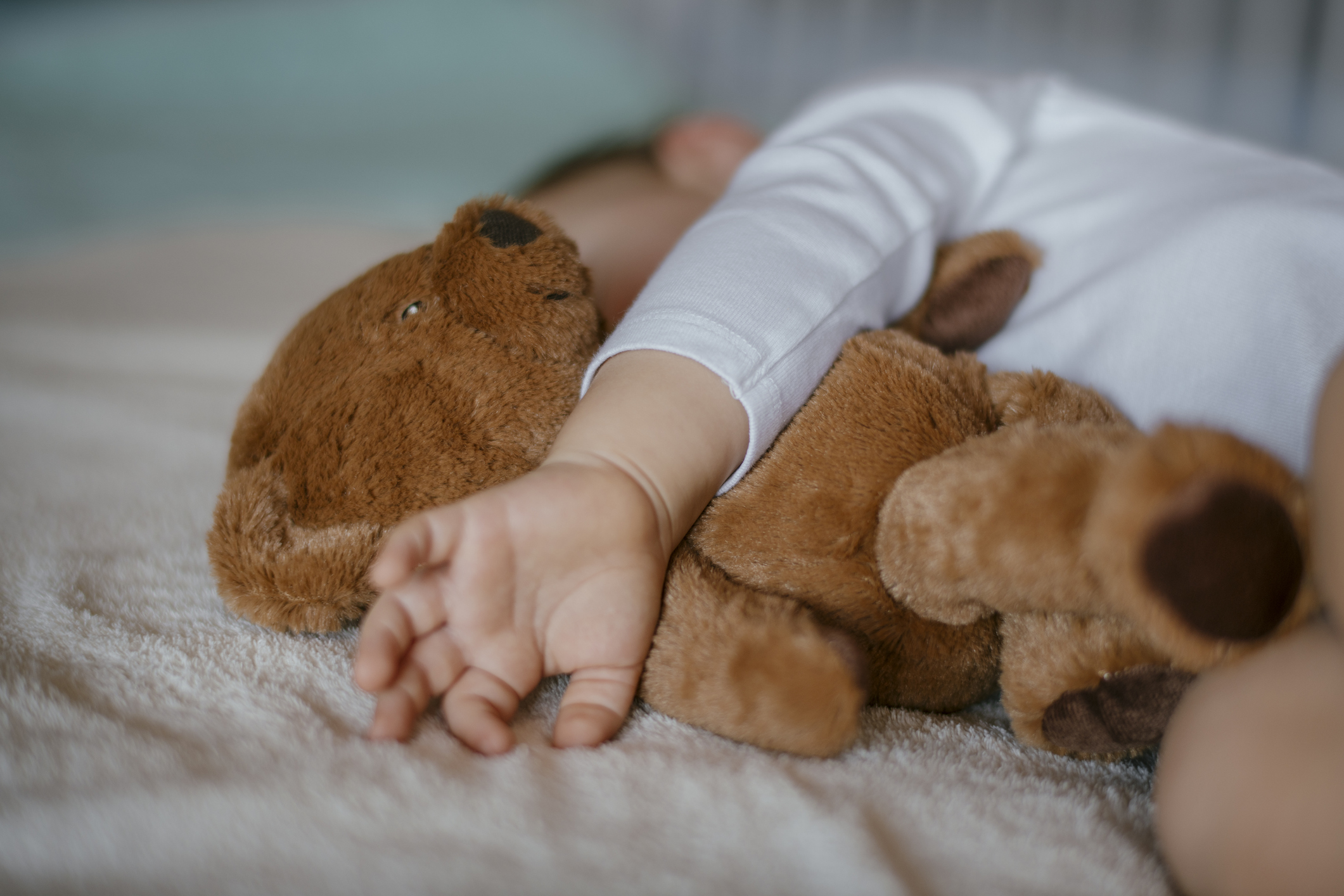 Baby sleeping with teddy bear