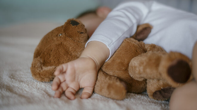 Child holding teddy bear
