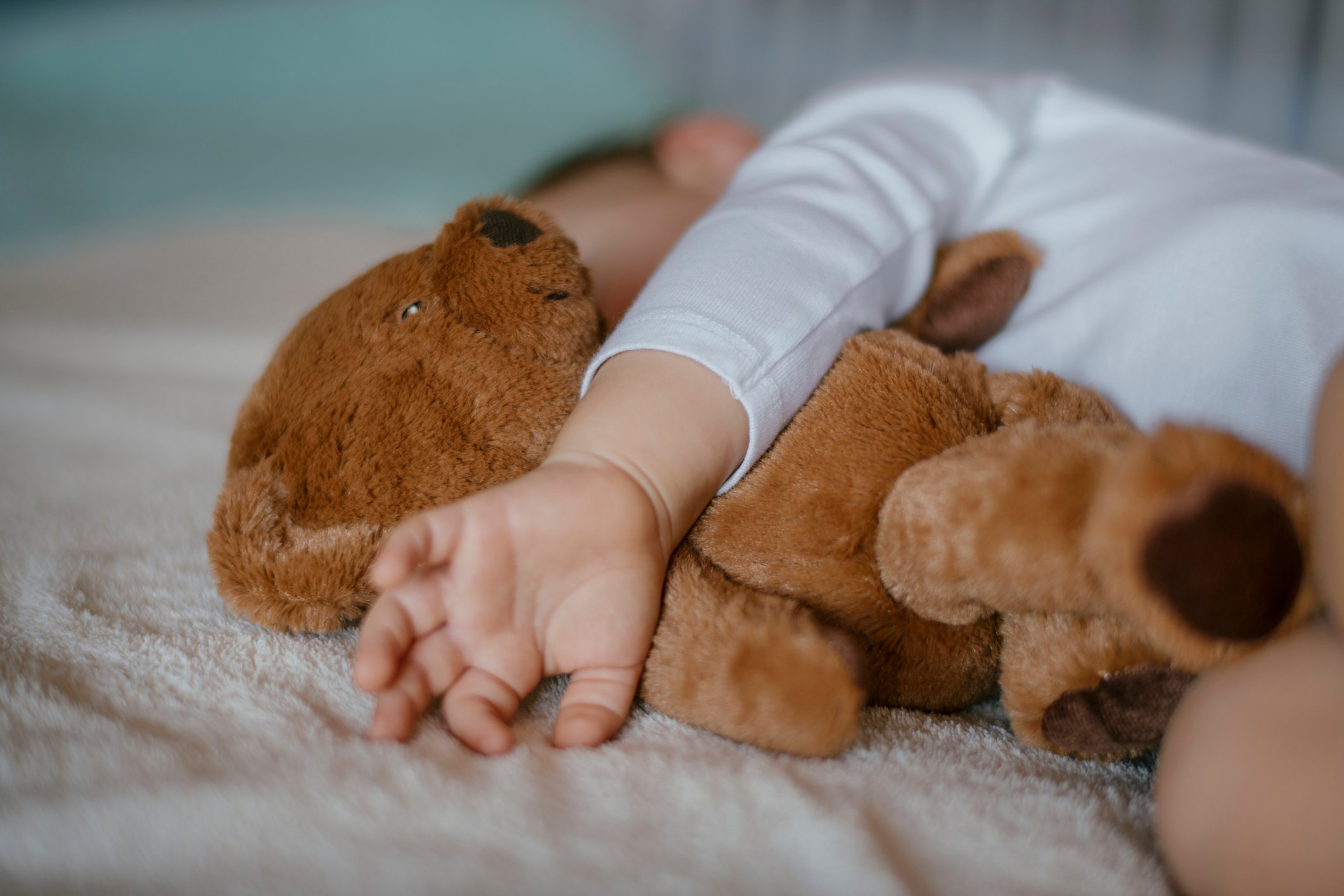 Child holding teddy bear