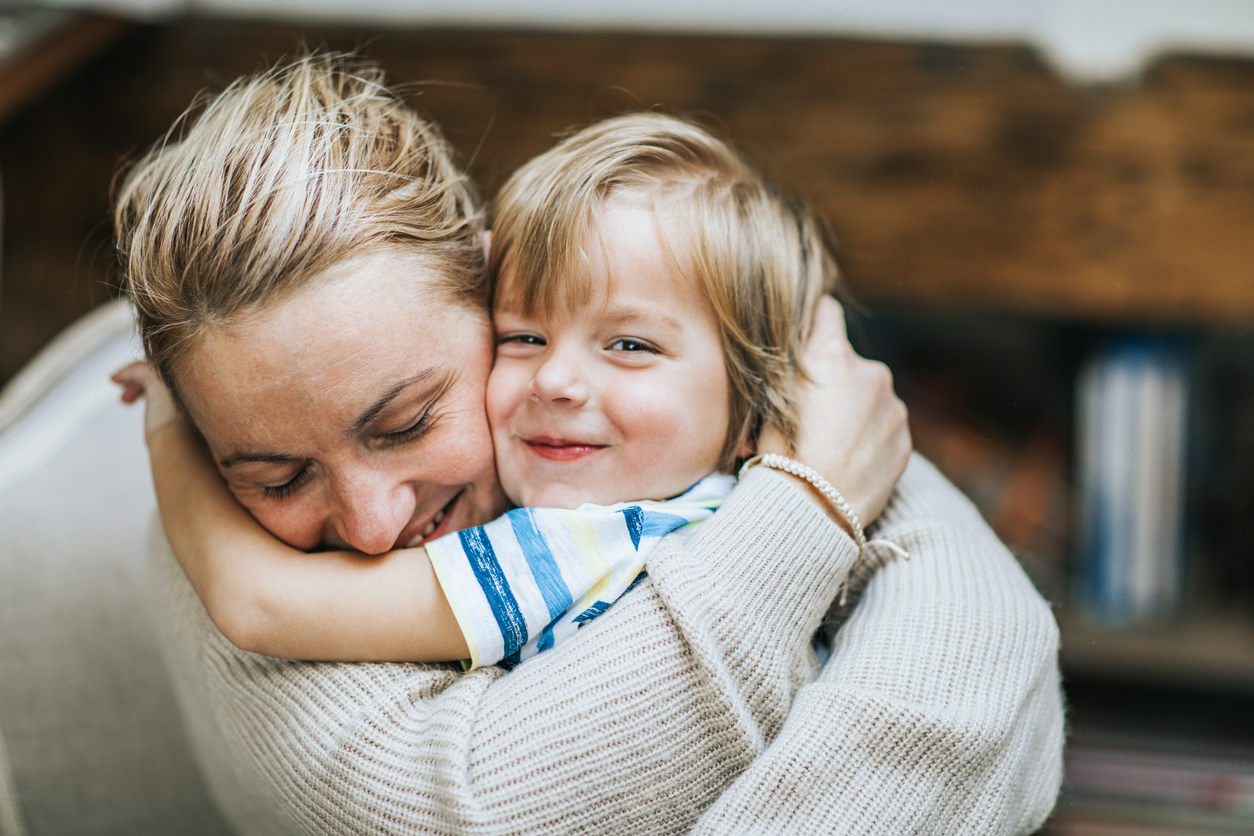 Affectionate mother and son embracing at home.