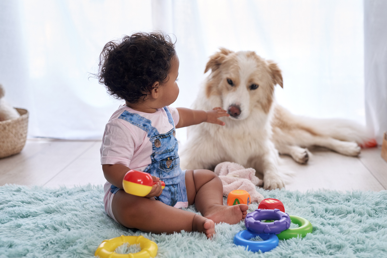 baby with pet dog at home