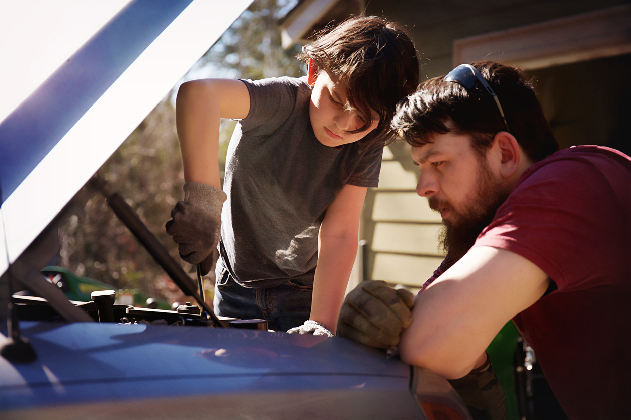 Father and son working on a truck