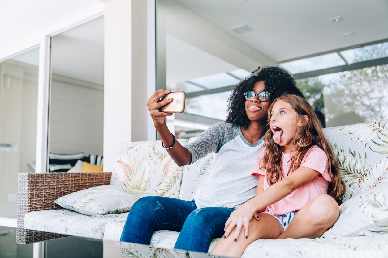 Two young friends making funny faces while taking a selfie