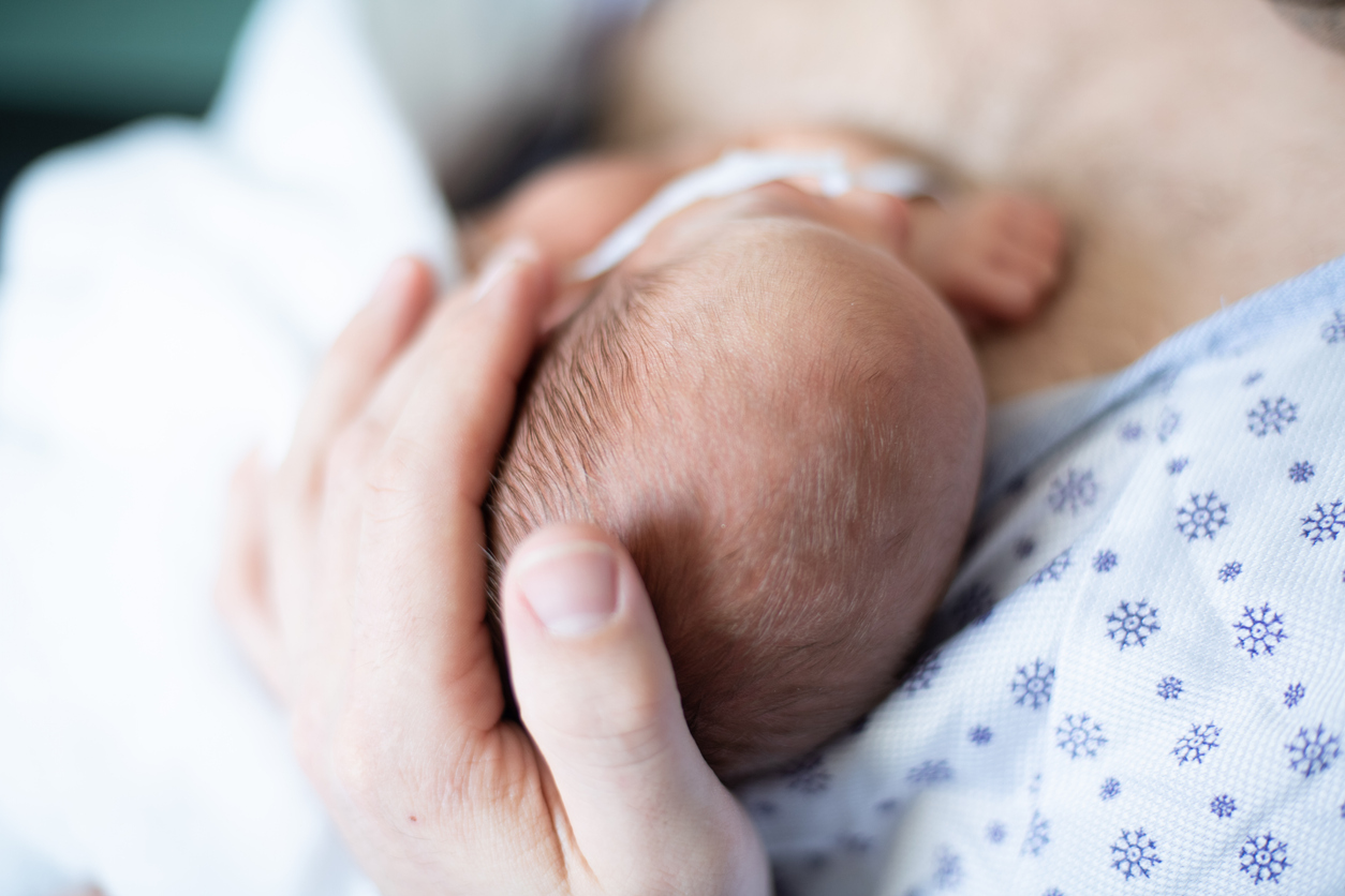 Father taking care of his premature baby doing skin to skin at hospital