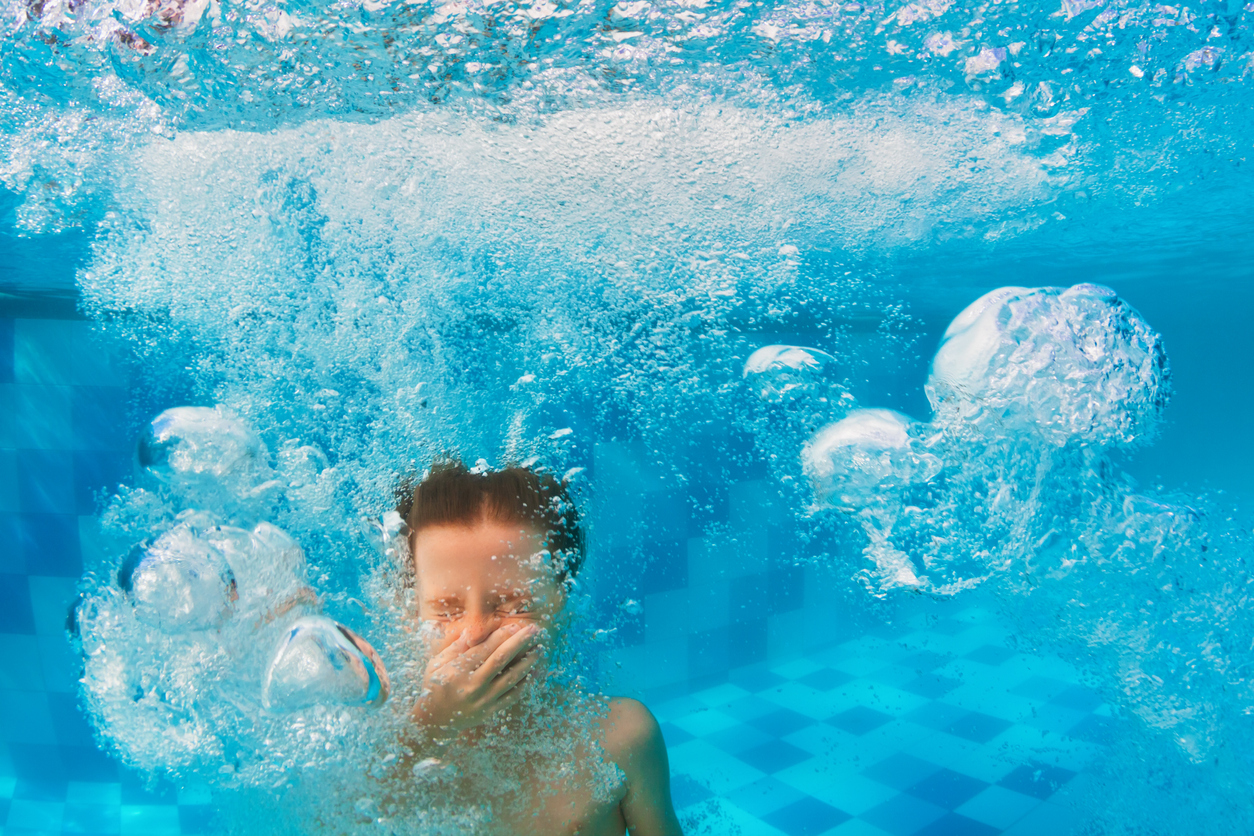 Boy diving in swimming pool