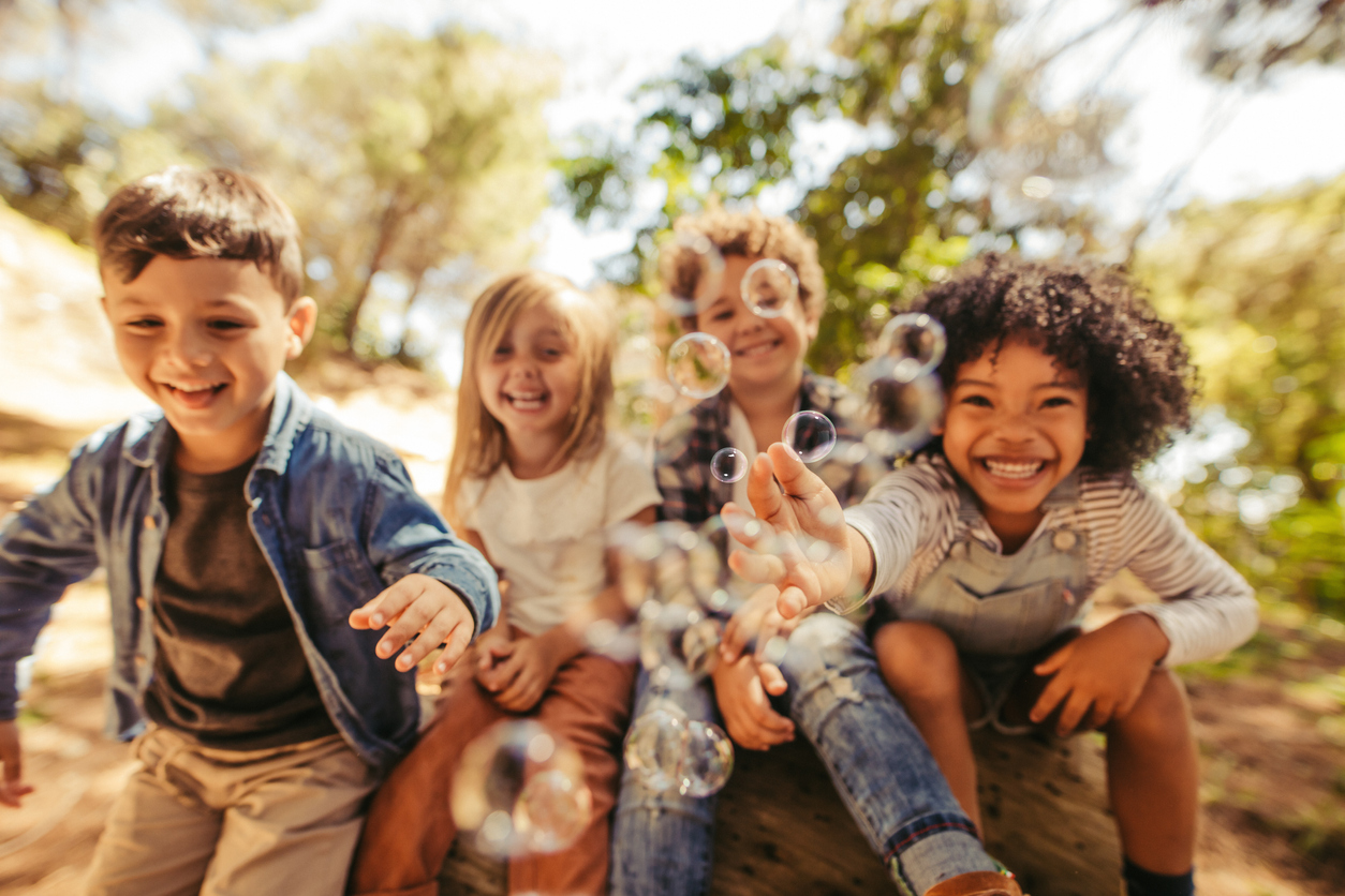 Group of children playing with soap bubbles