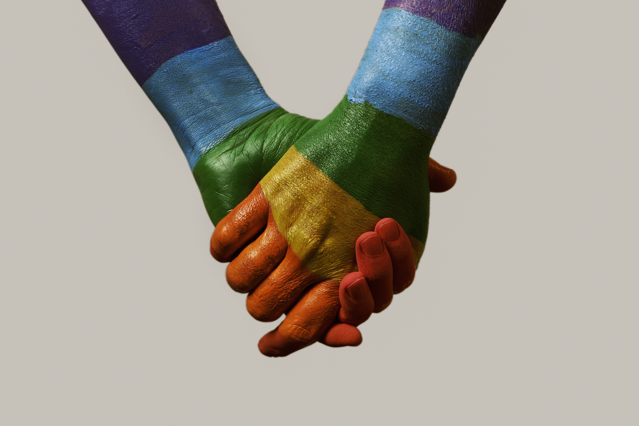 hands patterned with the rainbow flag