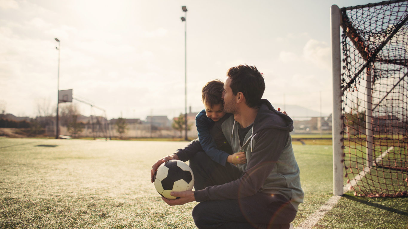 Father and son on a soccer court