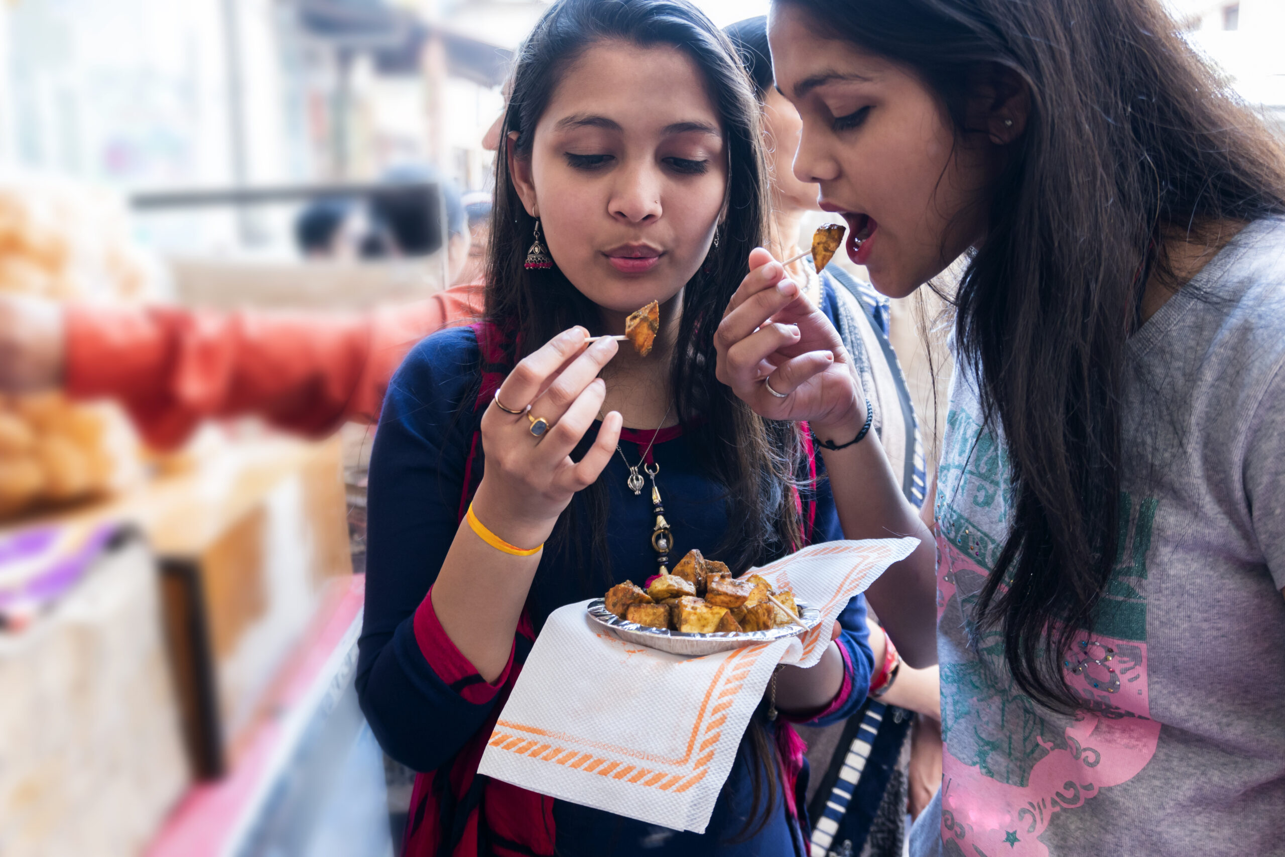 girls eating Aloo Chaat street food