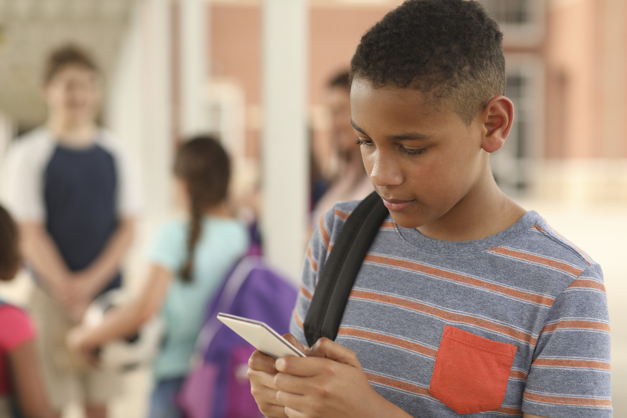 African descent, junior high age boy on school campus.