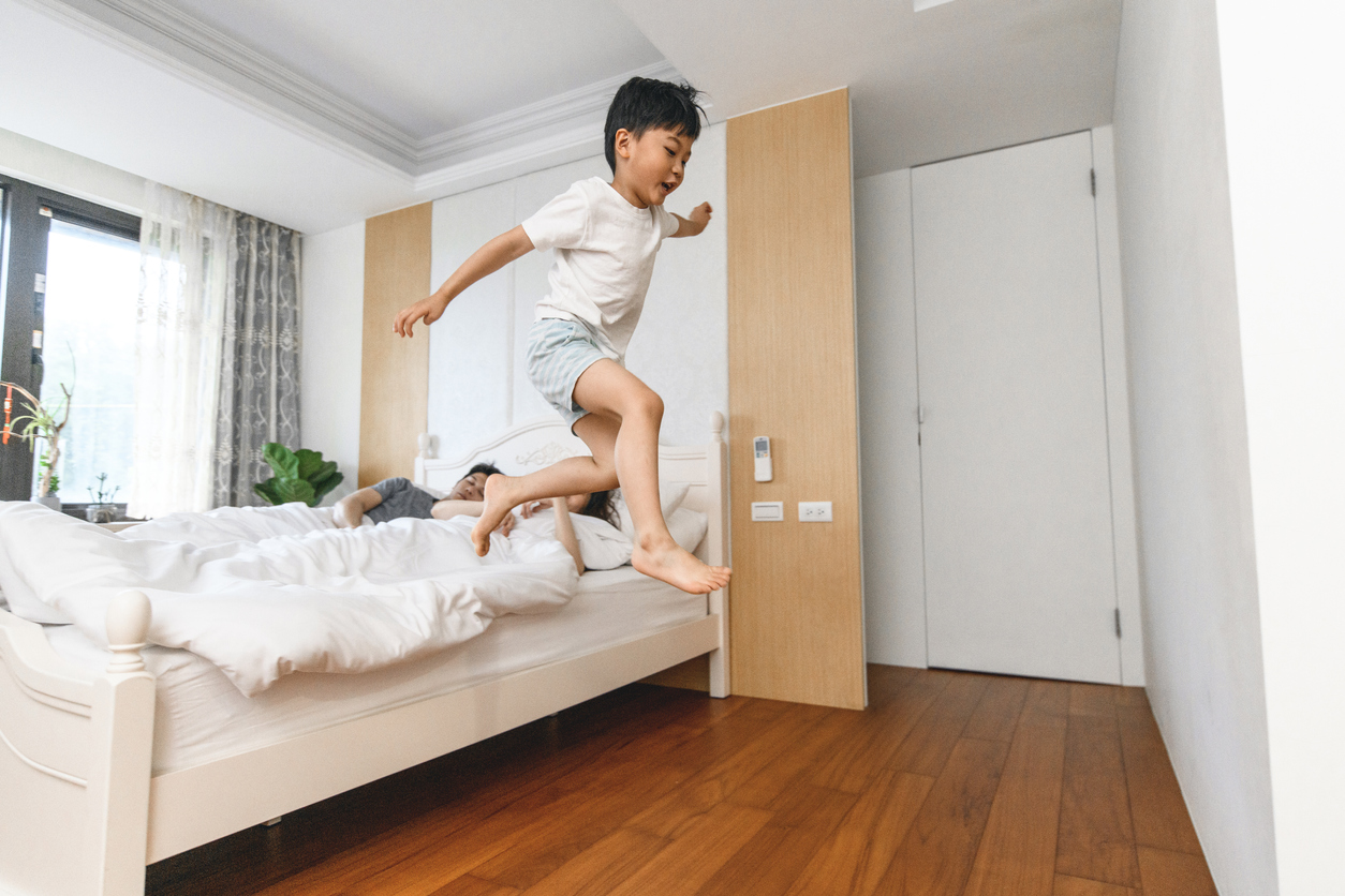 Playful Taiwanese Boys Jumping Off the Bed in the Morning