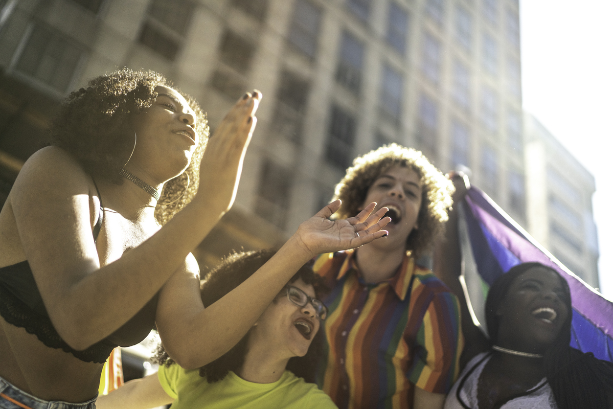 Friends shouting during pride parade