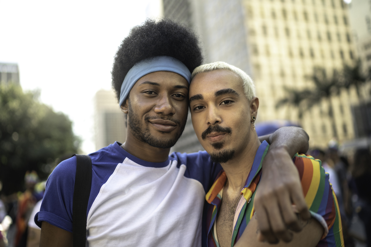 Male couple embracing during LGBTQI parade