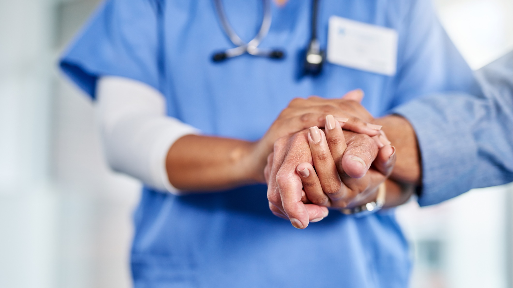 Nurse holding patient hand