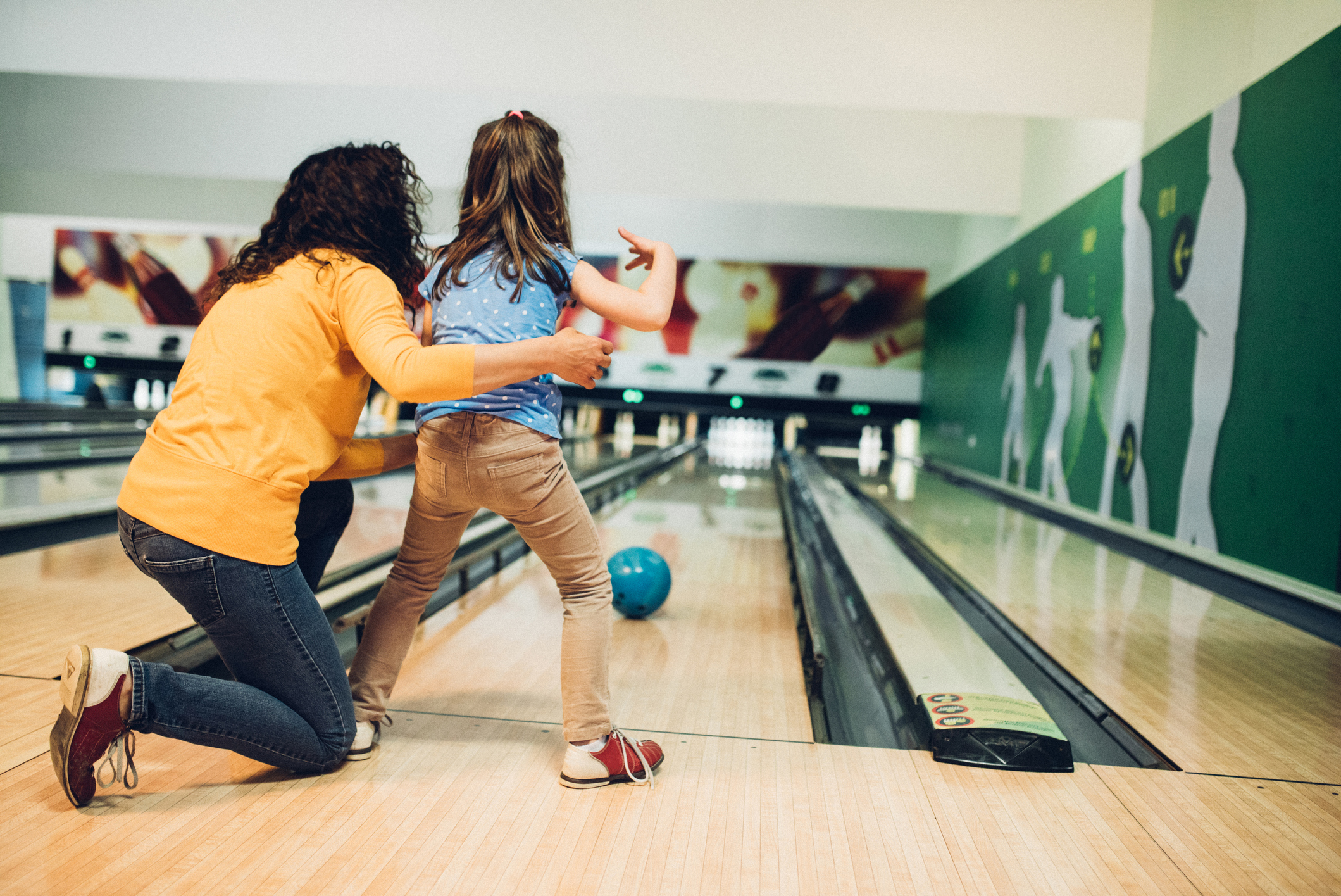 Mother and daughter bowling together