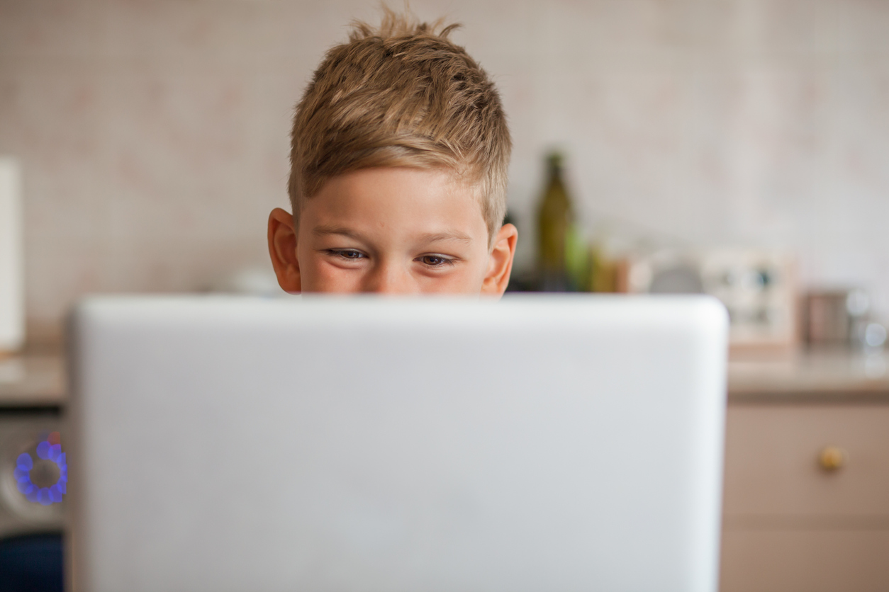 Smiling boy looking at laptop