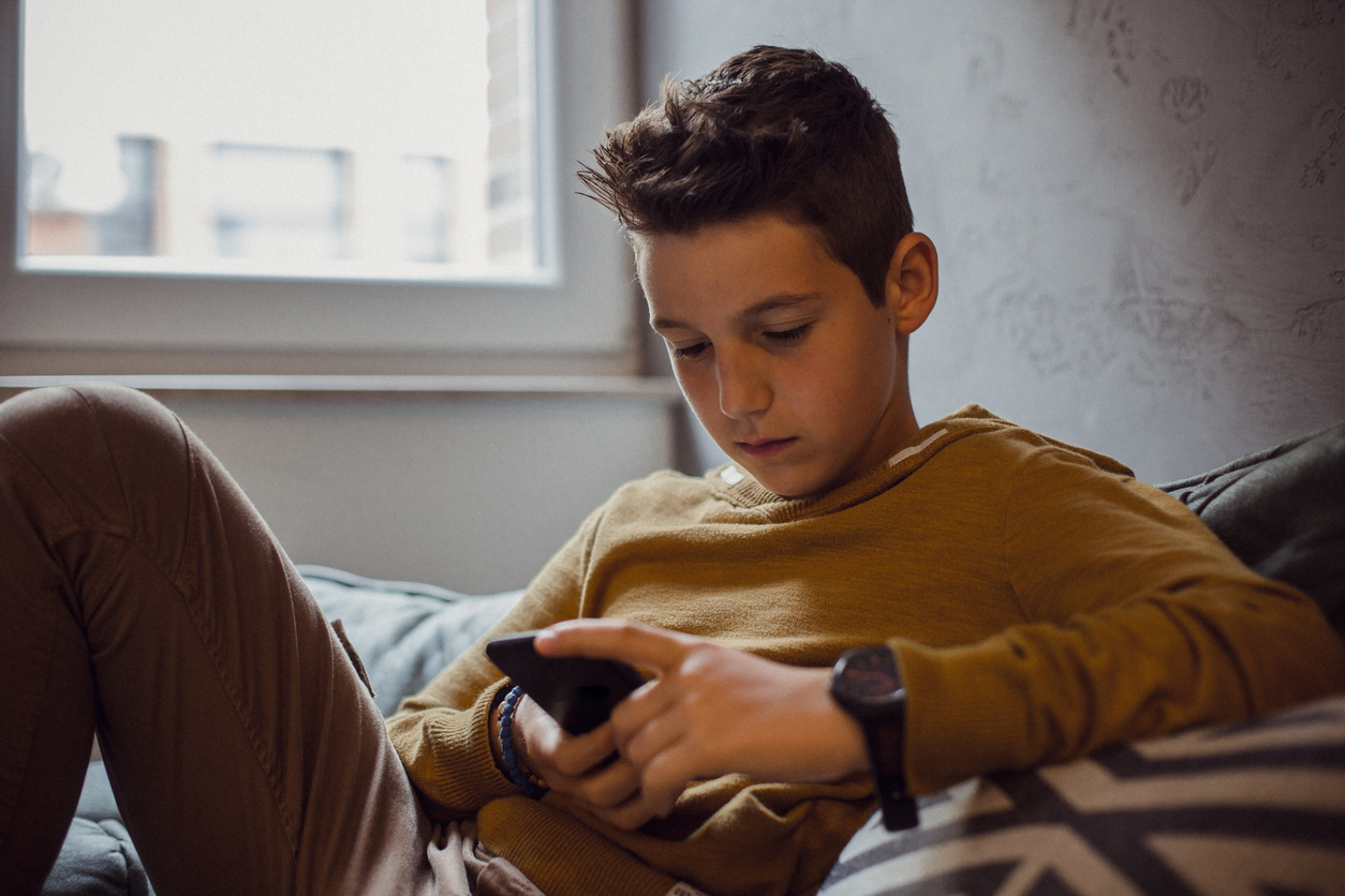 Teenage Boy Relaxing in his Bedroom