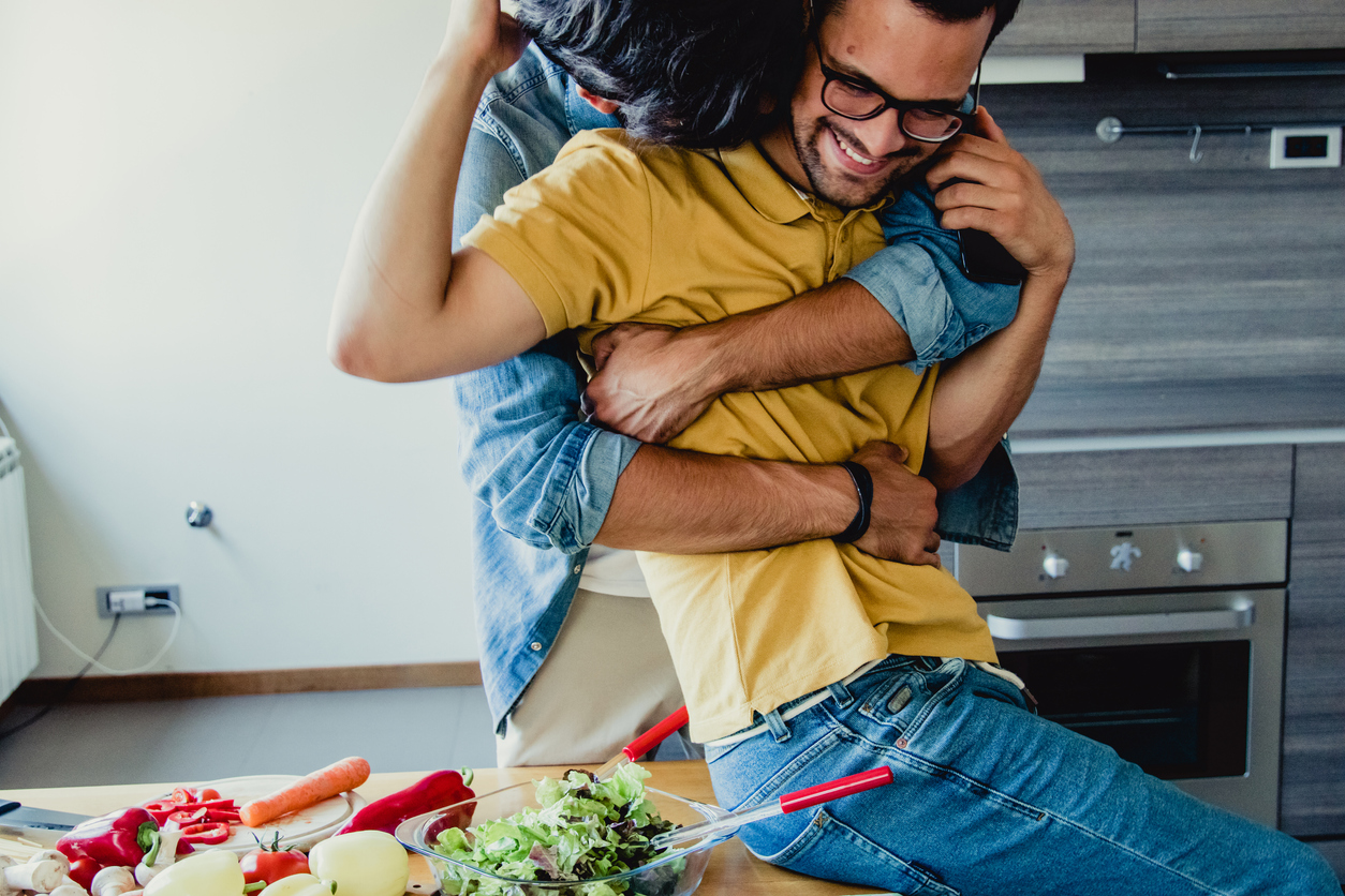 gay couple cooking and having fun