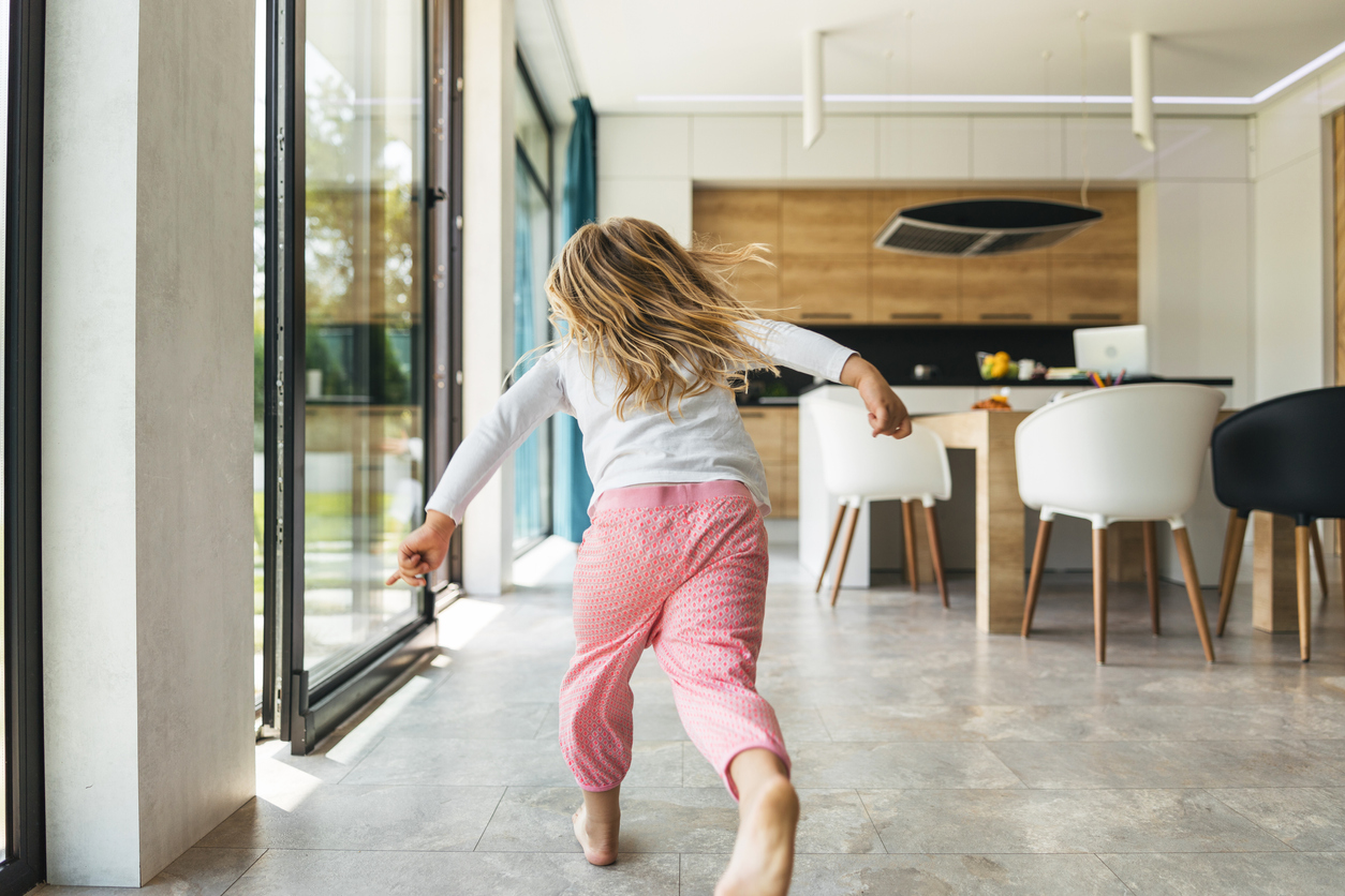 Running child in pajama at home stock photo