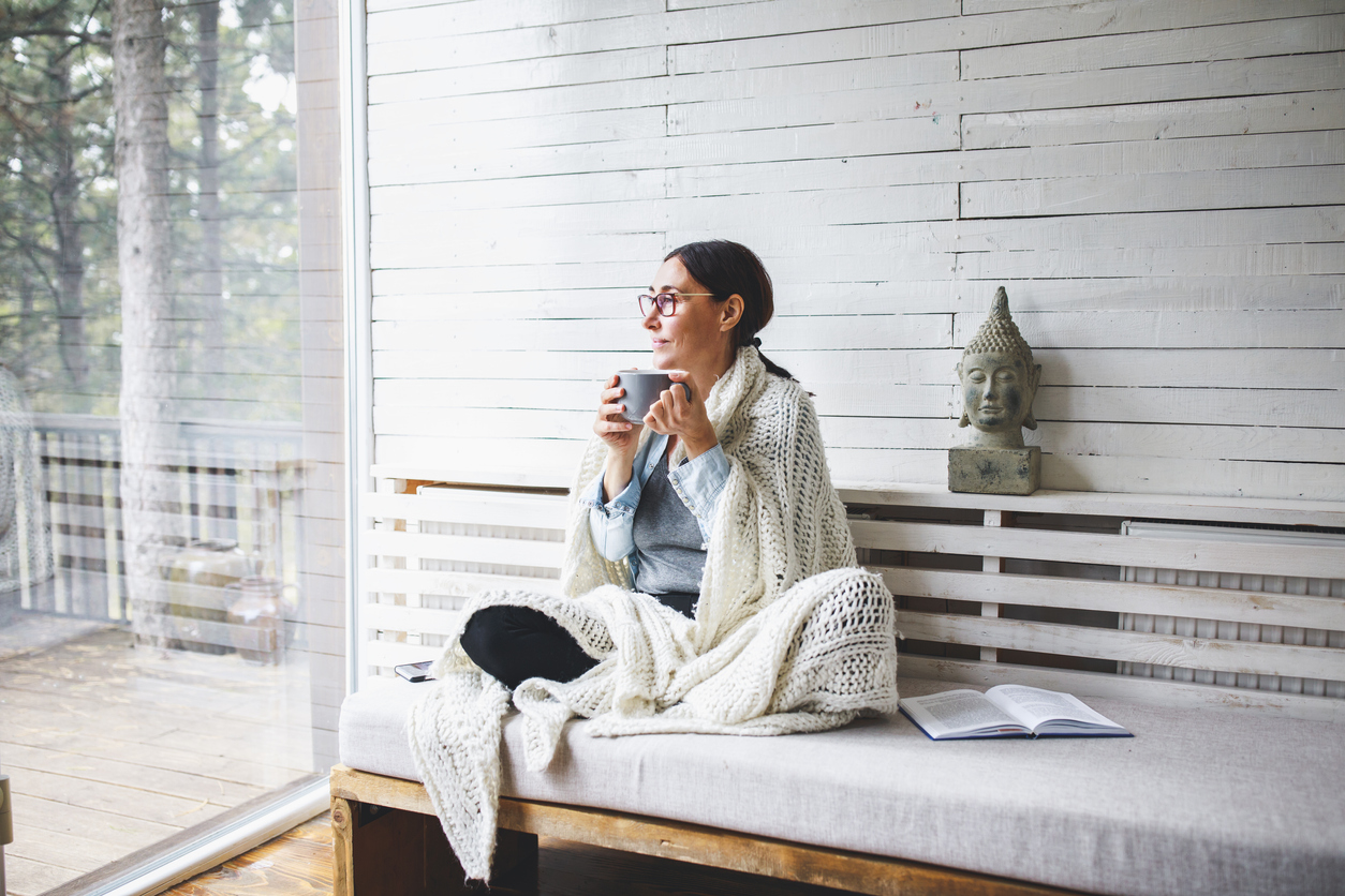 Woman sitting comfortable and looking through the window