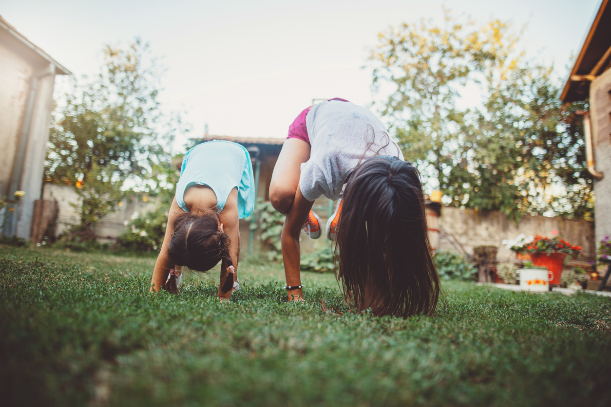 Mom and daughter doing yoga outdoors