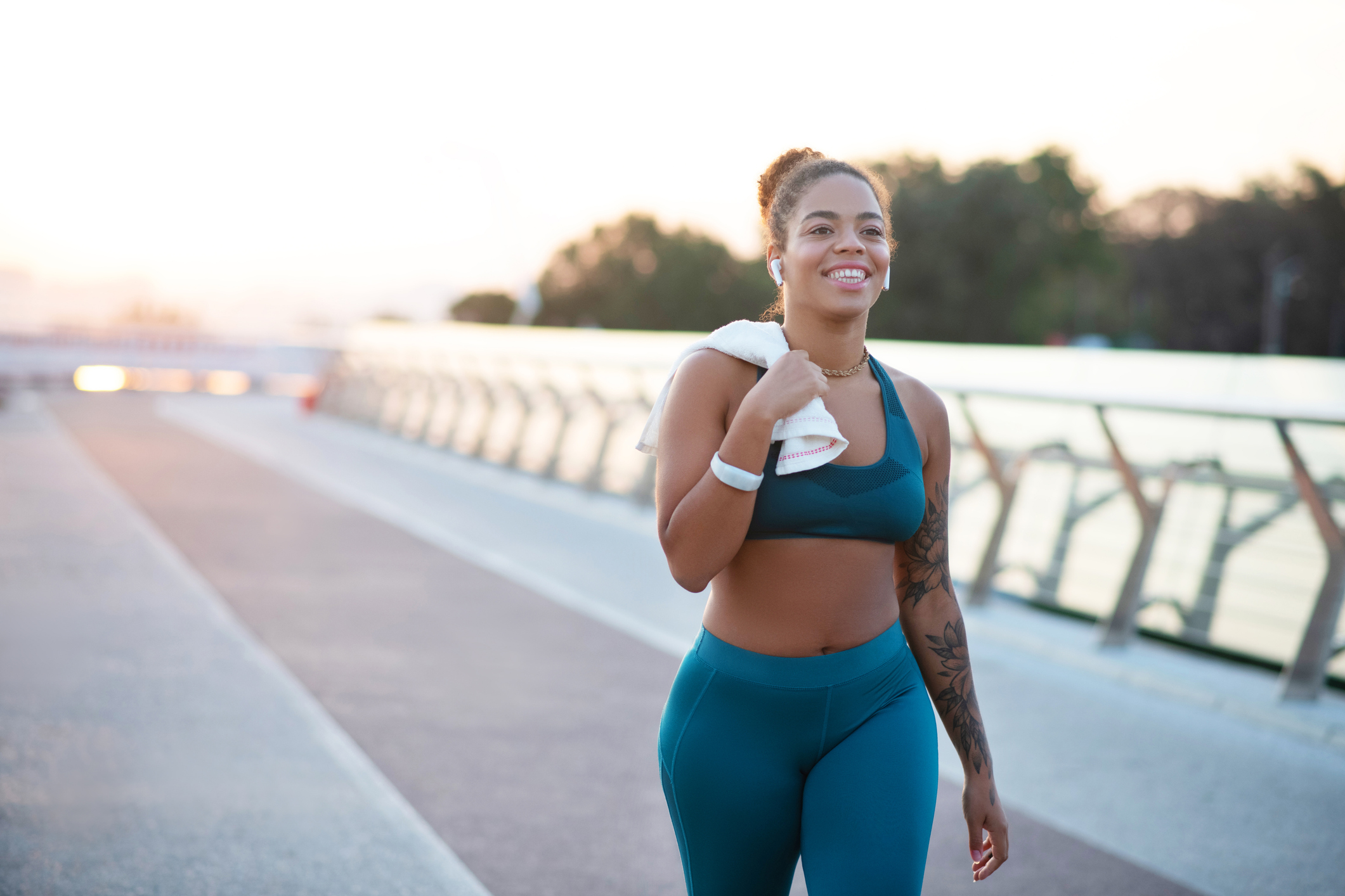 Tattooed young woman going home after running in the morning