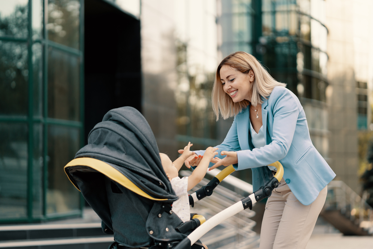 Portrait of a successful business woman in blue suit with baby