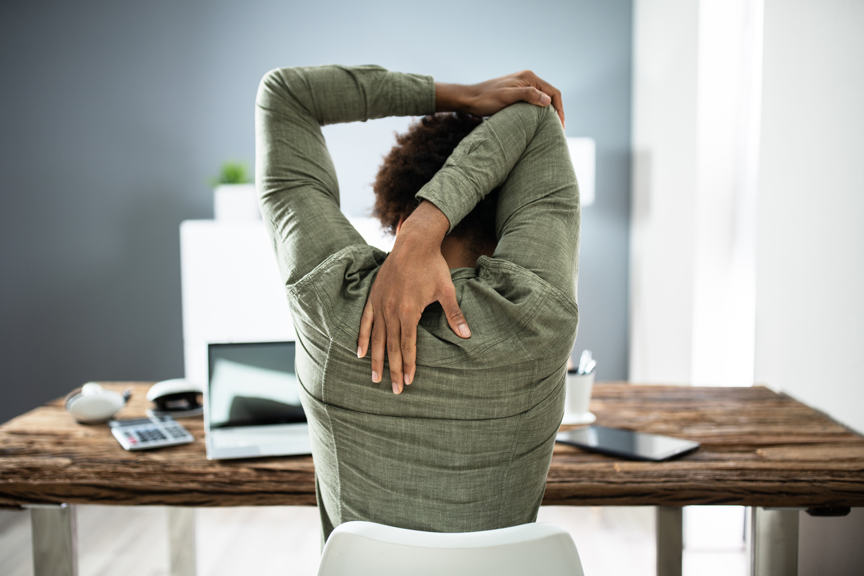 Rear View Of A Businessman Stretching His Arms