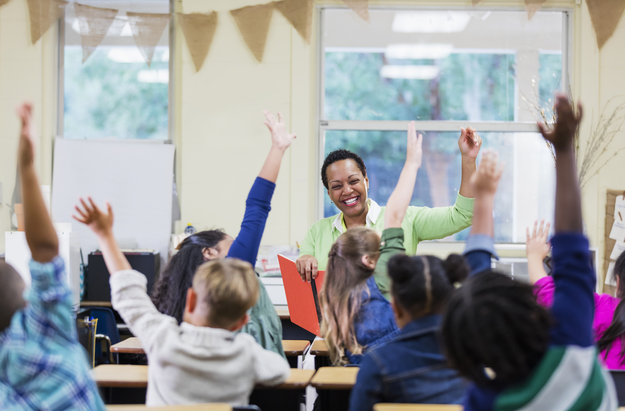 African-American teacher reading to school children