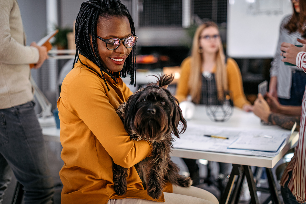 Businesswoman with pet dog at office